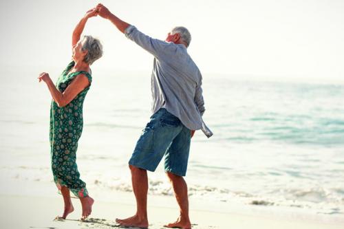 Senior couple dancing on beach