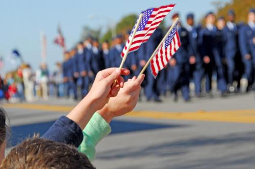 Waving American flag at military parade